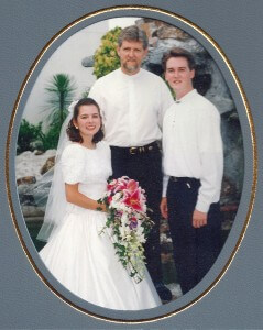 Our wedding day, with our pastor, Ernie.