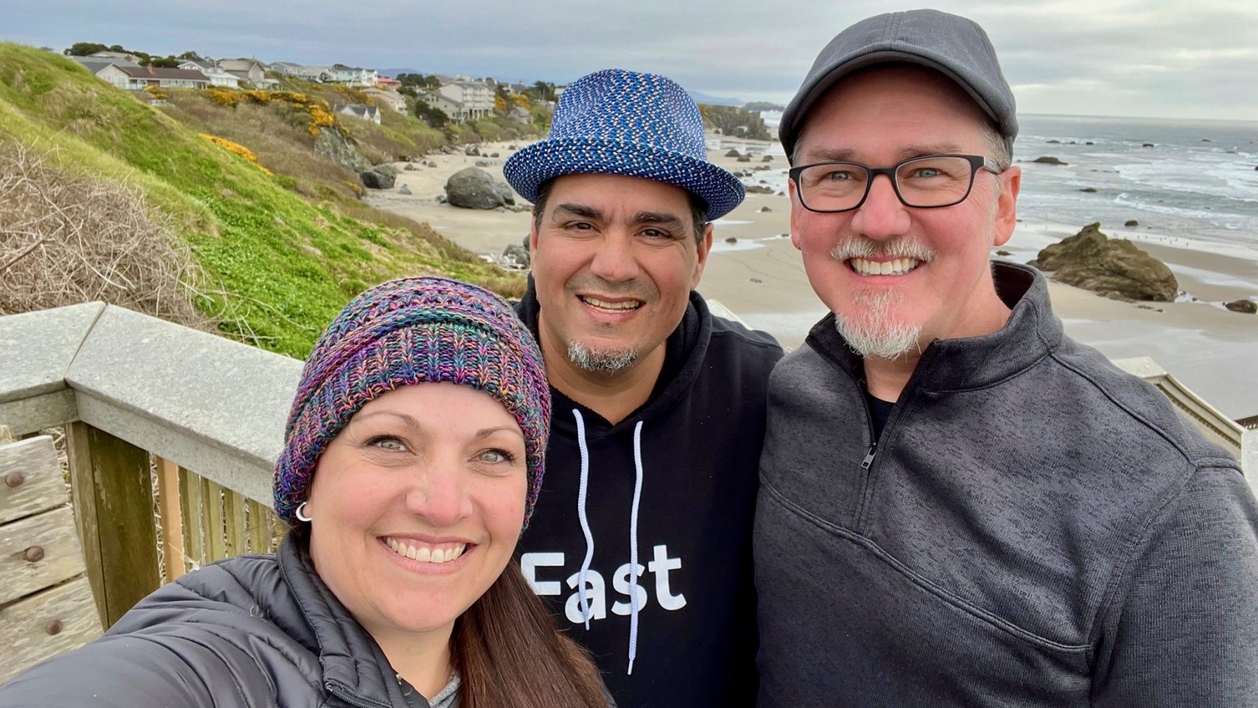 Photo of Jennifer Bourn, Chris Lema, and Shawn Hesketh with the Oregon coast in the background.